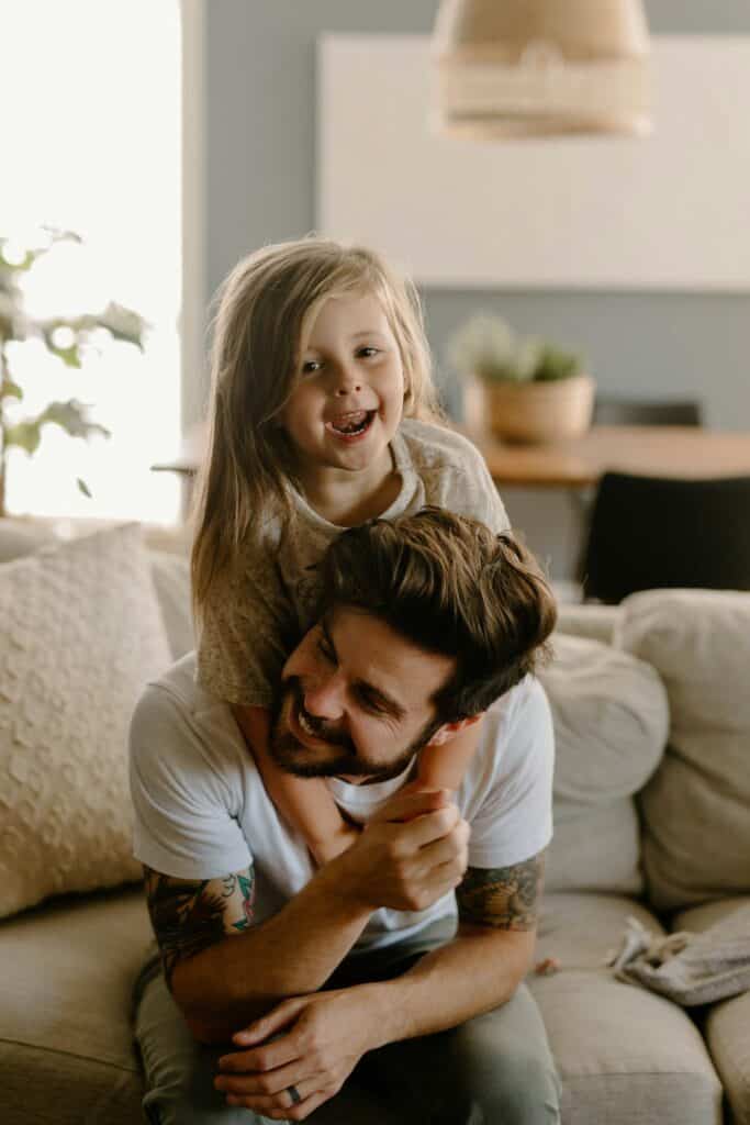 Joyful father and daughter enjoying time at home during relocation.